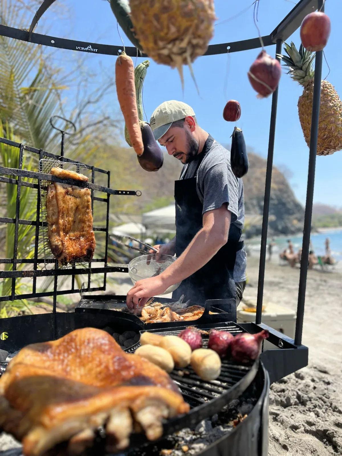 Chef preparing a meal over live fire