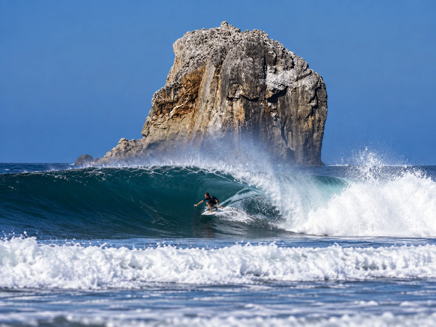 Surfer riding a wave at Witch's Rock in Guanacaste